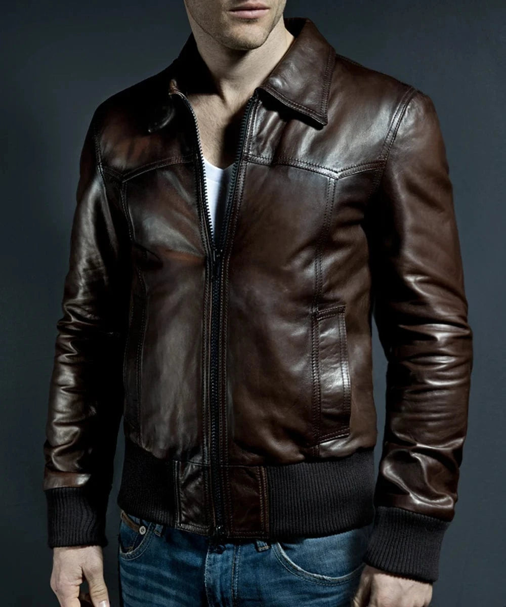 Model wearing vintage brown leather bomber jacket with slim fit styling and ribbed knit trim, worn zipped