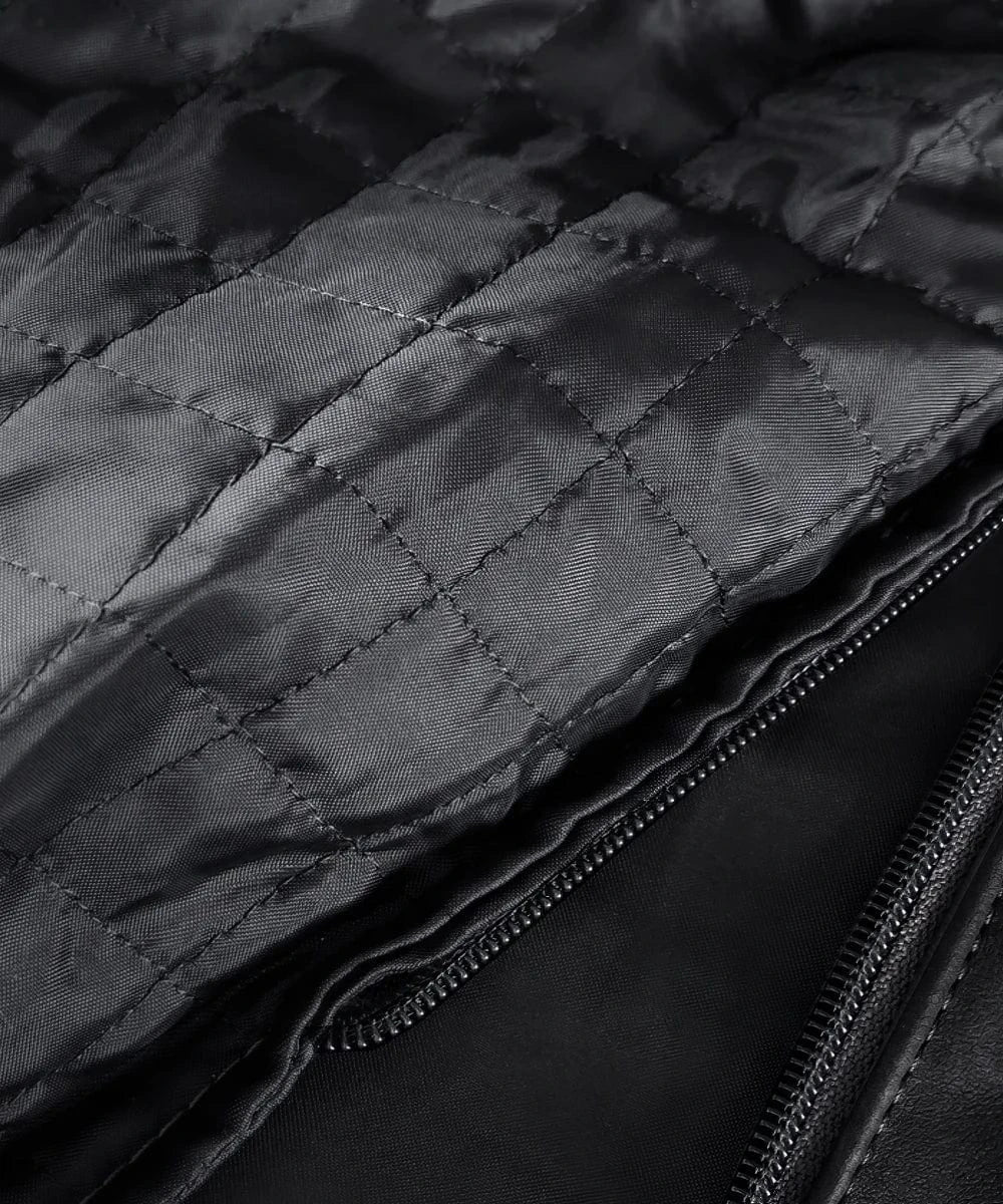 Close-up view of quilted black lining and inner zipper detail inside vintage slim fit black calf leather jacket