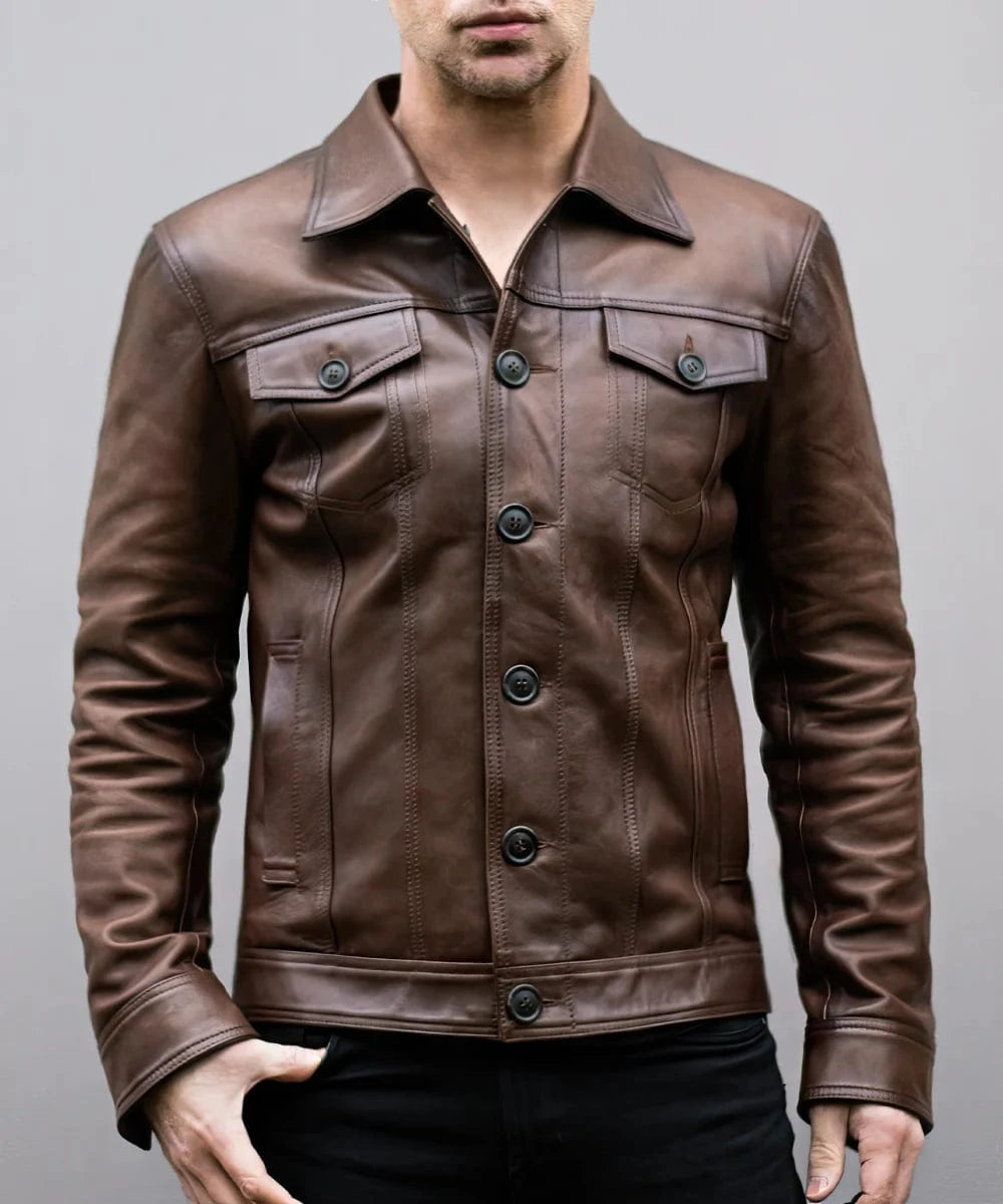 Model wearing vintage brown leather trucker jacket with slim fit styling and classic trucker inspired design